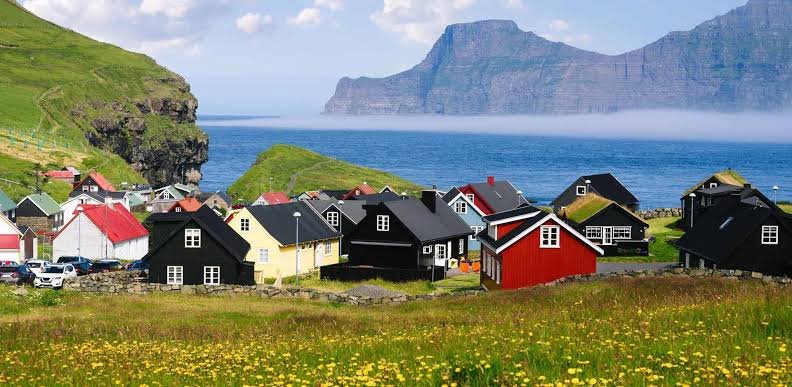 Misty cliffs of the Faroe Islands with sea waves crashing into dramatic landscapes: digital detox gateways