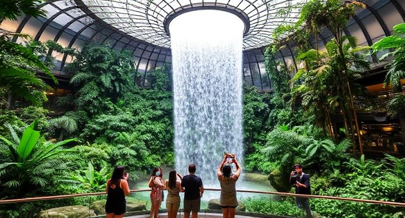 Jewel Changi’s Rain Vortex indoor waterfall with tourists around – exciting travel to Singapore in unbelievably best budget
