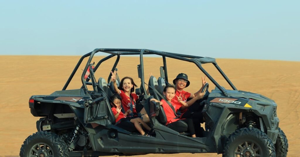 Happy family exploring the Dubai desert with an off-road buggy, creating fun and lasting memories.