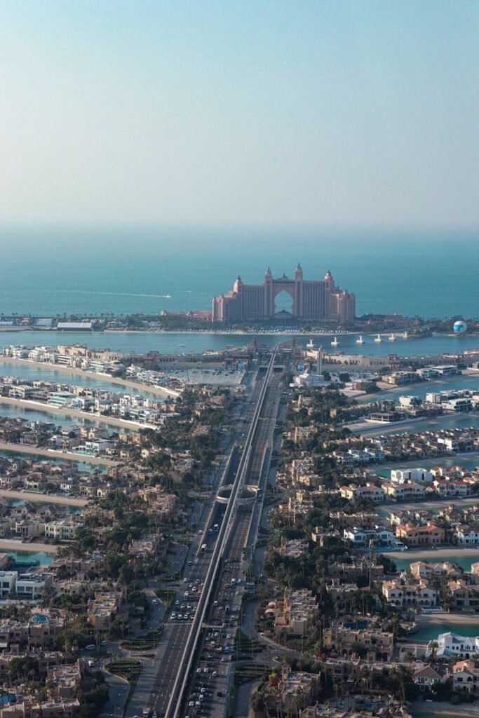 Stunning aerial shot of Atlantis Hotel with Palm Jumeirah in Dubai, under clear blue skies.