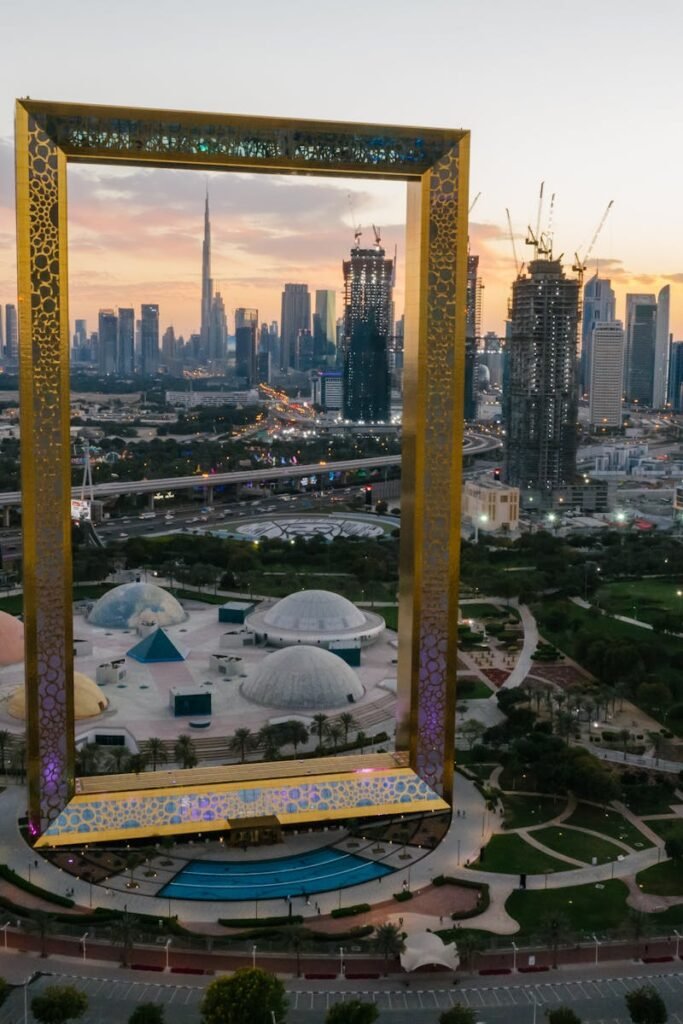 Aerial view of Dubai Frame with cityscape backdrop at sunset. Iconic landmark in UAE.