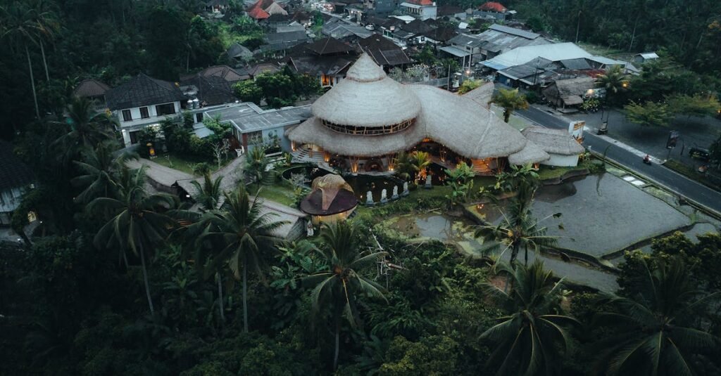 A stunning aerial view of a bamboo resort in Tegallalang, Bali, Indonesia, surrounded by lush greenery.